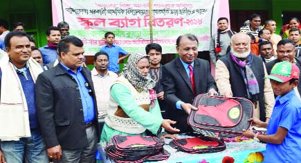NETRAKONA: Cultural Secretary of Bangladesh Awami League Ashim Kumar Ukil distributing school bags among the students of Sandikona Government Primary School at Kendua Upazila on Saturday.