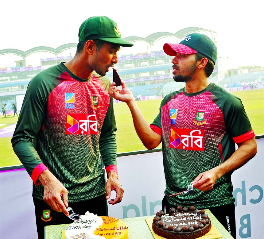 Mominul Haque (right) offering the birthday cake to Mahmudullah Riyad at the Sher-e-Bangla National Cricket Stadium in the city's Mirpur on Sunday. Riyad's birthday was on Sunday.