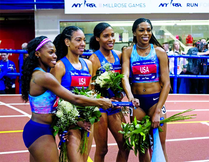 From left: Team mates Chrishuna Williams, Charlene Lipsey, Ajee' Wilson and Raevyn Rogers pose for photographers after winning the Jack and Lewis Rudin women's 4x800-meter relay race in the Millrose Games track and field meet in New York on Saturday. Th
