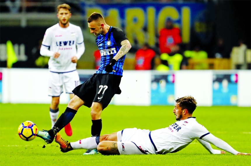 Crotone's Federico Ceccherini tackles Inter Milan's Marcelo Brozovic during an Italian Serie A soccer match between Inter Milan and Crotone at the San Siro stadium in Milan, Italy on Saturday.