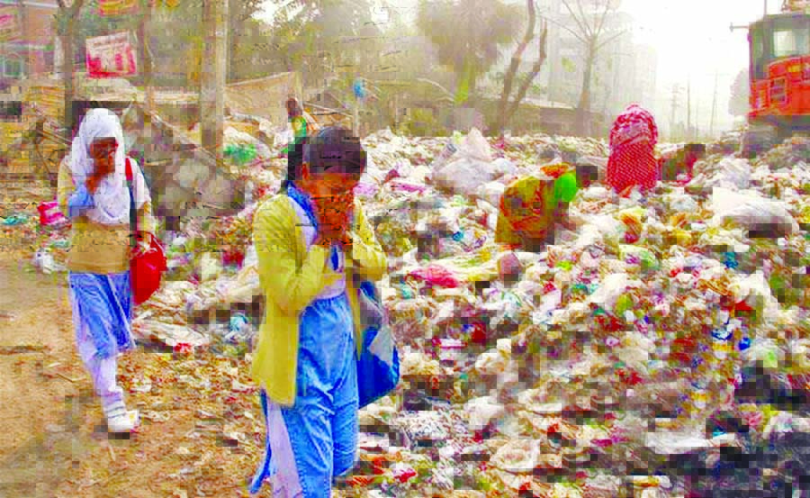 Covering their noses common people including school children passing through road which is filled up with garbage. The situation remains the same for long, but the authority concerned seemed to be blind to remove this nuisance for the benefit of the road