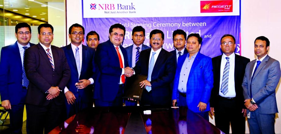 Md. Mehmood Husain, Managing Director of NRB Bank Limited and Hanif Zakaria, Chief Commercial Officer of Regent Airways, exchanging an agreement signing documents at the bank's head office in the city on Sunday. Under the deal, Credit Cardholders of the