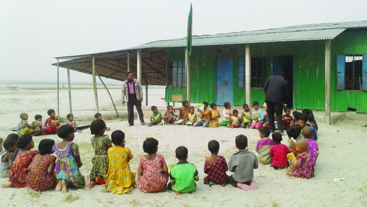 GANGACHARA(RANGPUR): Students of Gangachara Chilakhalchar Government Primary School attending classes under the open sky due to shortage of classrooms as a portion of the school have been eroded by Teesta River. This snap was taken yesterday.