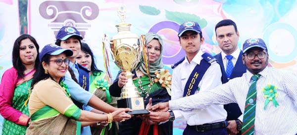 Salma Binte Karim, wife of Brigadier General Md Mefta Ul Karim, handing over the trophy to the members of Buriganga House, the champions of the Annual Sports Competition of Mirpur Cantonment Public School & College on Monday.