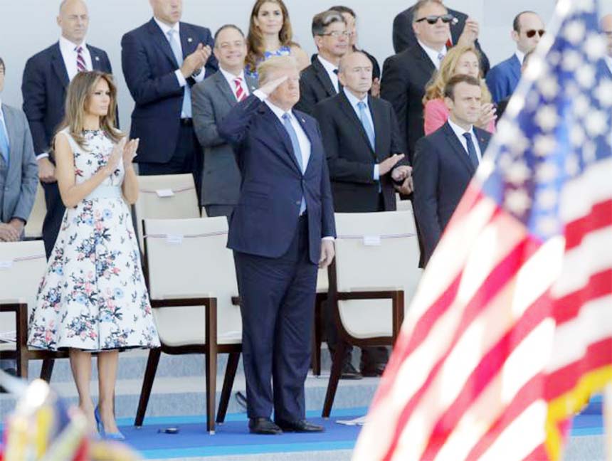 President Trump and first lady Melania Trump watch the Bastille Day military parade on the Champs ElysÃ©es, in Paris along with French President Emmanuel Macron, right.