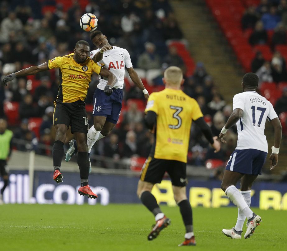 Newport's Frank Nouble (left) leaps to head the ball with Tottenham's Serge Aurier during the English FA Cup fourth round replay soccer match between Tottenham Hotspur and Newport County at Wembley stadium in London on Wednesday.