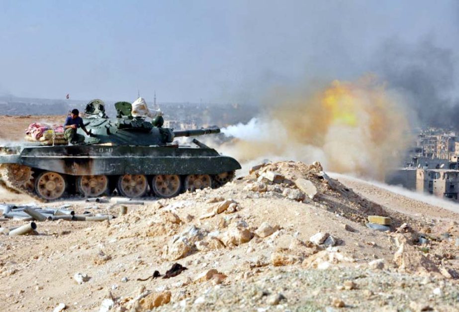 Syrian pro-government forces pound Islamic State group positions in the eastern province of Deir Ezzor with tank fire during an operation against the jihadists.
