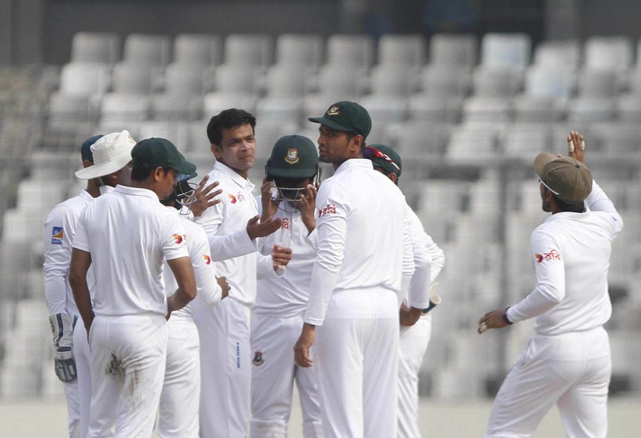 Experienced left-arm spinner Abdur Razzak (without cap) of Bangladesh celebrates with his teammate after dismissal of a Sri Lanka wicket during the first day of the second Test between Bangladesh and Sri Lanka at the Sher-e-Bangla National Cricket Stadium