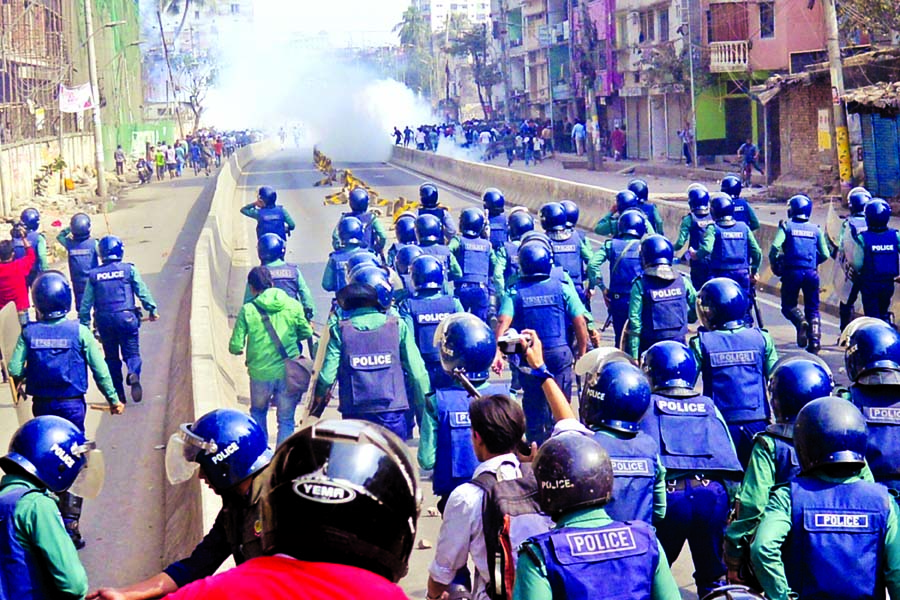 Police fire teargas shells to disperse the crowd of pro-BNP supporters while they were gathering at Chankherpool area centering the verdict in Khaleda Zia orphanage graft case on Thursday.