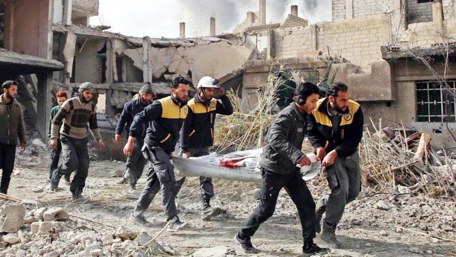 Members of Syrian civil defence forces known as White Helmets evacuate a victim of an air strike in the rebel-held enclave of Hazeh in the Eastern Ghouta near Damascus on Thursday.