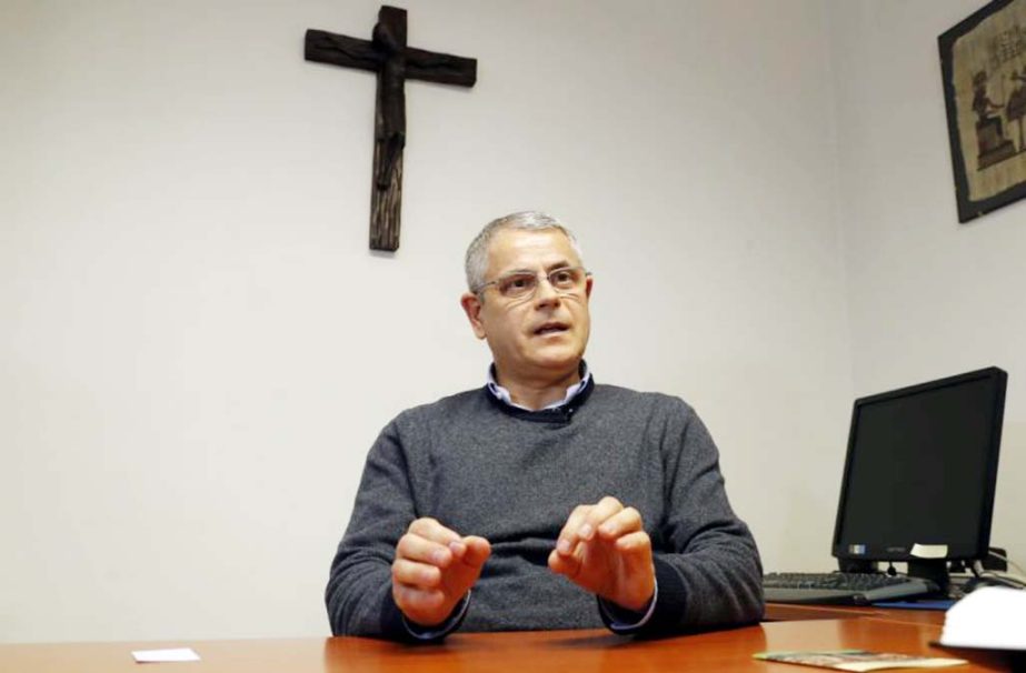 The head of the immigration office at the Verona diocese, Giuseppe Mirandola, talks with the Associated Press in Verona, Italy. Racist and anti-Semitic expressions have been growing more bold, widespread and violent in Italy.