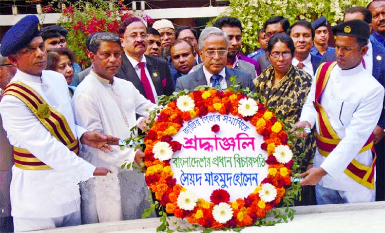 Chief Justice Syed Mahmud Hossain paying tributes to Father of the Nation Bangabandhu Sheikh Mujibur Rahman placing floral wreaths at the latter's mazar at Tungipara in Gopalganj on Friday.