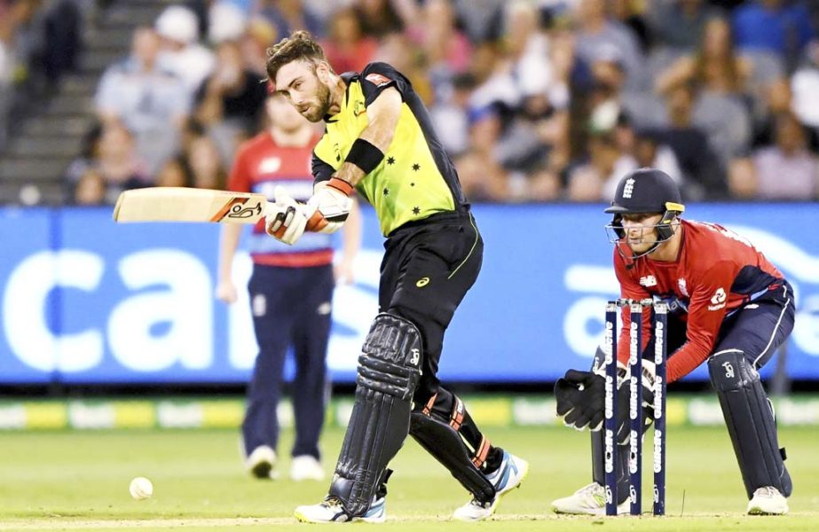 England's Jos Buttler (right) watches as Australia's Glenn Maxwell drives the ball during their Twenty20 cricket match in Melbourne, Australia on Saturday.