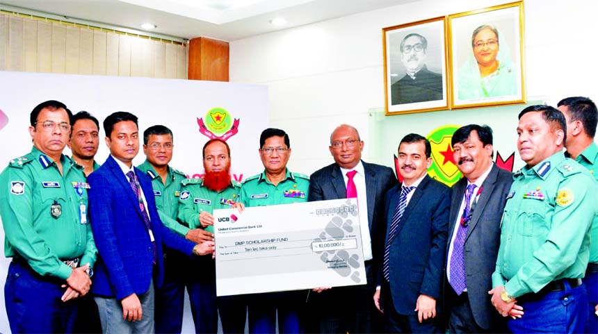 AE Abdul Muhaimen, Managing Director of United Commercial Bank Limited, handing over the donation cheque to Md. Asaduzzaman Mia, Commissioner of Dhaka Metropolitan Police for the scholarship fund of DMP. Other senior officials from both the organizations