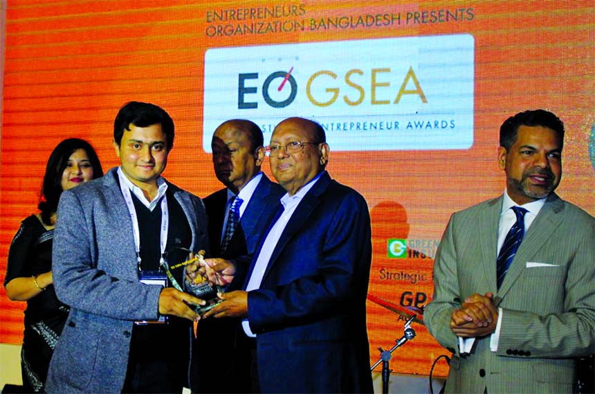 Commerce Minister Tofail Ahmed, handing over a crest to Eshan Sadashivan, CEO of PROSOC, for winning regional global student entrepreneur Awards arranged at a programme in the city recently. Zareen Mahmud Hosein, GSEA Co-Chair and Hossain Khaled, former D