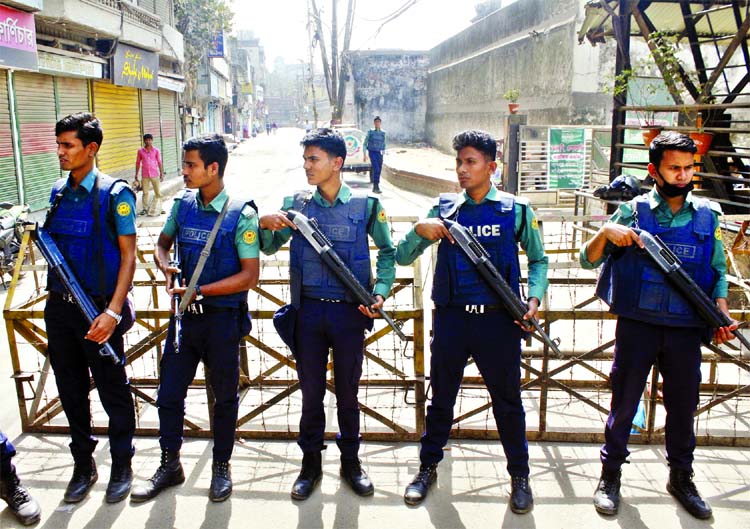 Police stand guard as security was beefed up around the old Dhaka Central Jail where BNP Chairperson Begum Khaleda Zia being imprisoned. This photo was taken on Sunday.