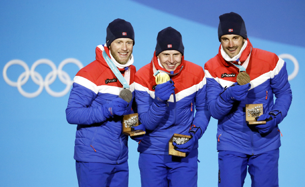 Men's cross-country 1515km skiathlon medalists from left Norways' Martin Johnsrud Sundby (silver), Simen Hegstad Krueger (gold) and Hans Christer Holund (bronze) pose during their medals ceremony at the 2018 Winter Olympics in Pyeongchang, South Korea