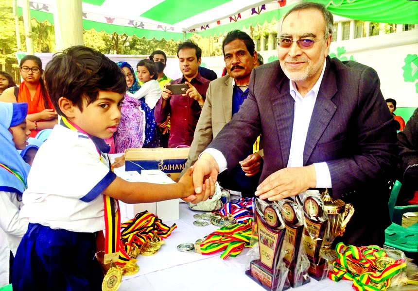 Principal of Iranian International School and Cultural Councillor of Iran Cultural Centre Syed Mussa Hossaini shaking hands with Bashir Ahmed, who won the prize of the ' Champion of the Year' of the Annual Sports Competition of the School at Government