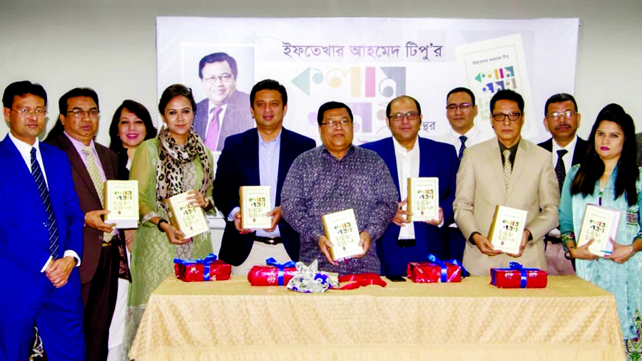 Chairman of Efad Group Iftekhar Ahmed Tipu along with others holds the copies of a book titled 'Column Samagra' at its cover unwrapping ceremony at its office in the city on Monday.