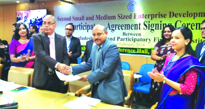 Shafique-ul-Azam, Managing Director of Midas Financing Limited and Md. Abul Bashar, General Manager of Financial Inclusion Department of Bangladesh Bank (BB), exchanging a participatory financial institutions agreement on refinance under 'Second Small an