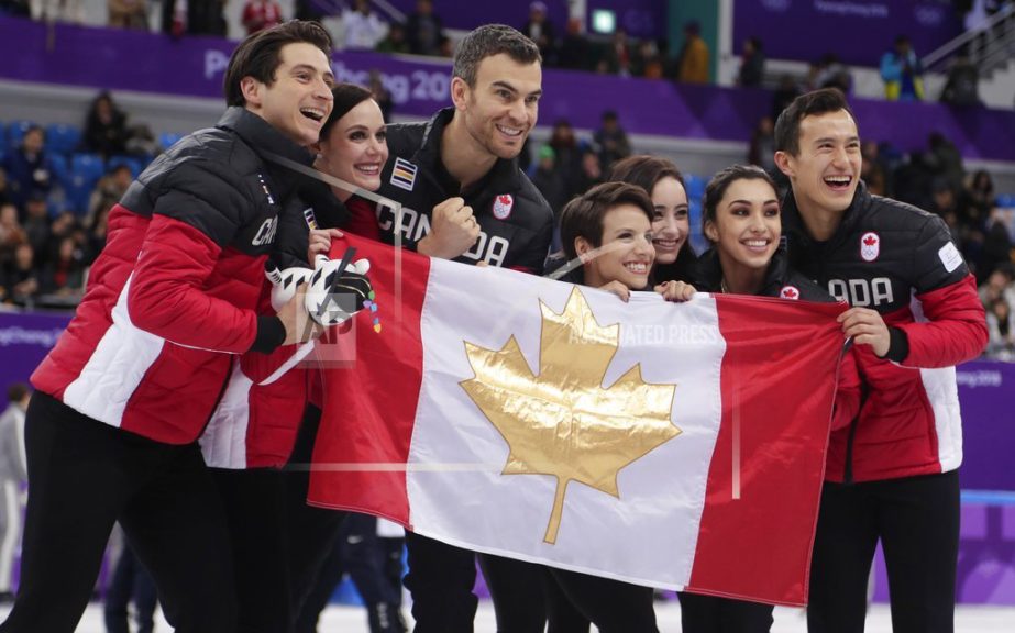 The Canadian team pose for a group photo following the Venue Ceremony after winning the gold medal in the figure skating team event in the Gangneung Ice Arena at the 2018 Winter Olympics in Gangneung, South Korea on Monday.