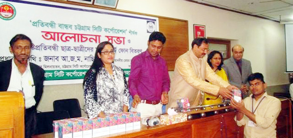 CCC Mayor A J M Nasir Uddin distributing smart phones among the blind students in the Port City orgasnised by CCC on Tuesday.