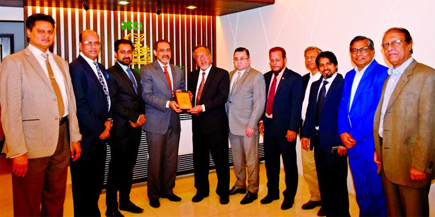 Dhaka Chamber of Commerce and Industry (DCCI) president Abul Kasem Khan handing over a crest to the Philippines Ambassador to Bangladesh Vicente Vivencio T Bandillo at DCCI office in the city recently. Top executives from both the organizations were also