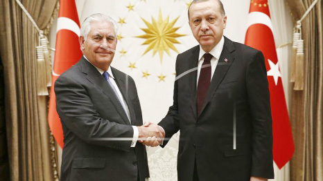 Turkey's President Recep Tayyip Erdogan, right, and US Secretary of State Rex Tillerson shake hands before their talks at the presidential palace in Ankara, Turkey, Thursday.