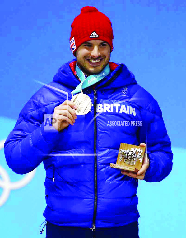 Bronze medalist in the men's skeleton Dom Parsons of Britain smiles during the medals ceremony at the 2018 Winter Olympics in Pyeongchang, South Korea on Friday.