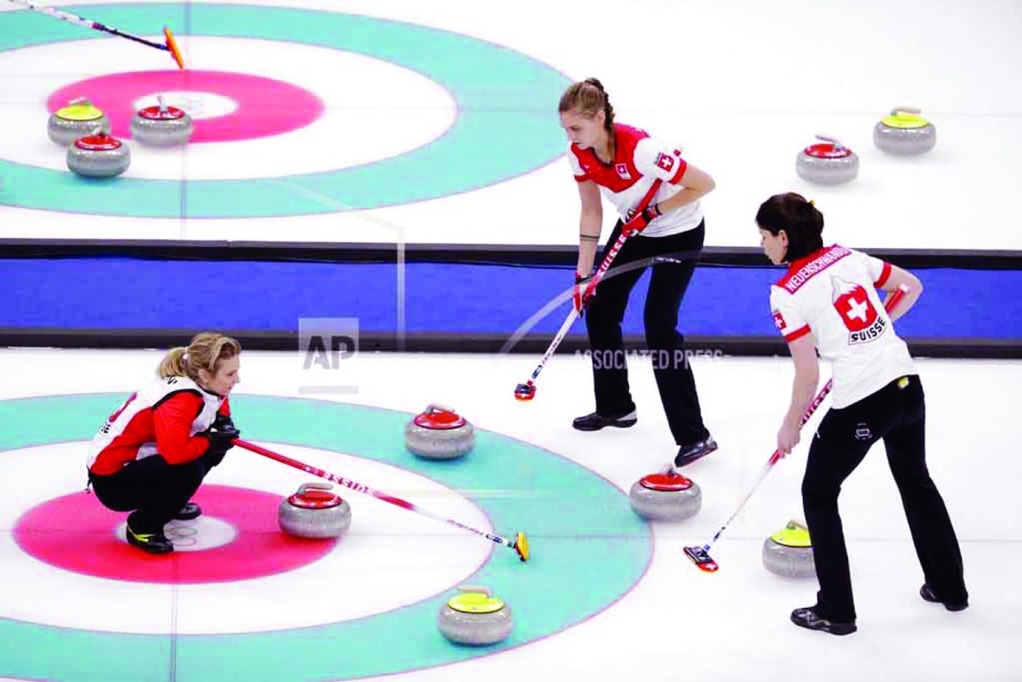 Switzerland's skip Silvana Tirinzoni (left) looks at her teammates sweep the ice during a women's curling match against South Korea at the 2018 Winter Olympics in Gangneung, South Korea on Friday.