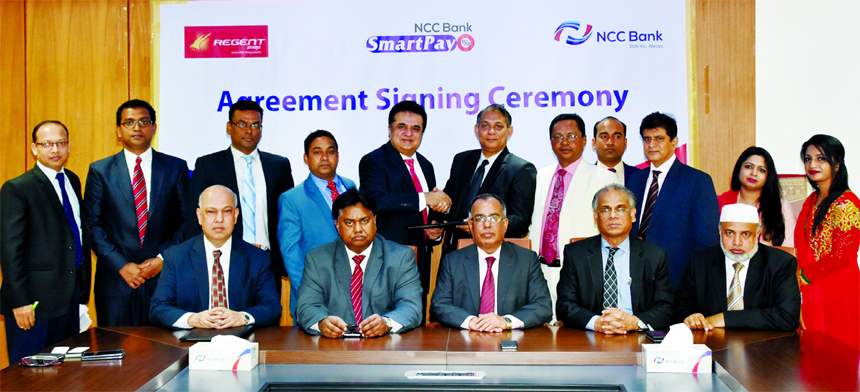 Khaled Afzal Rahim, Head of Cards of NCC Bank Limited and Hanif Zakaria, Chief Commercial Officer of Regent Airways, exchanging an agreement signing documents at a hotel in the city recently. Under the deal, Credit Cardholders of the bank shall get discou