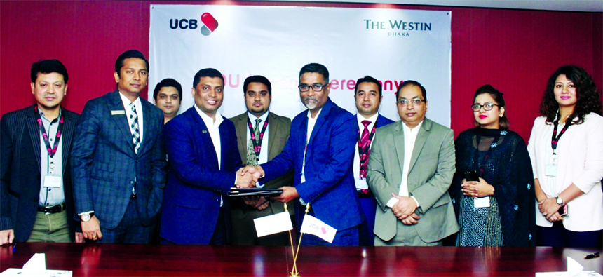 Taufiq Hassan, Executive Vice-President of United Commercial Bank Limited and Shakawath Hossain, Resident Manager of The Westin Dhaka, exchanging a MoU signing documents at the banks head office in the city recently. Senior officials from both the organiz