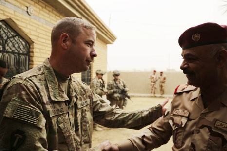 U.S. Army Lt. Col. Brandon Payne meets with his Iraqi counterpart at a small complex in the town of Qaim. As the fight against IS in Syria grinds on, Iraqi troops stationed in western Iraq near the border continue to call on coalition forces for help shar