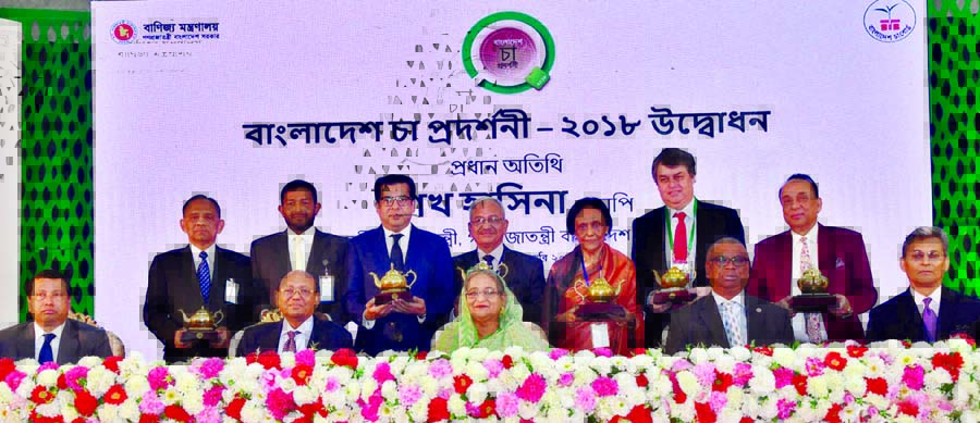 Prime Minister Sheikh Hasina at a photo session with the award recipients who played role in tea exporting and flourishing of tea industries at Bangabandhu International Conference Center in the city on Sunday. BSS photo