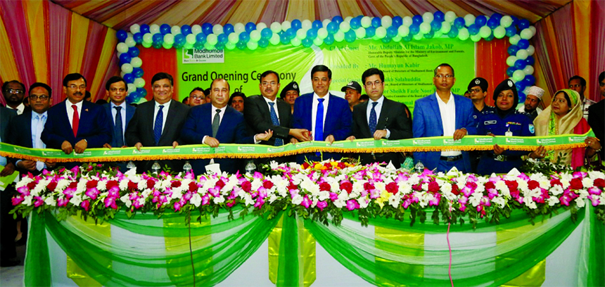Deputy Minister for the Ministry of Environment and Forests, Abdullah Al Islam Jakob, inaugurating the Shibpur Branch of Modhumoti Bank Limited at Shibpur in Narsingdi recently as chief guest. Humayun Kabir, Chairman of the Board of Directors, Barrister S