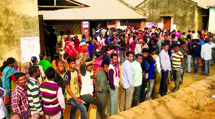 Voters wait to cast their votes near the Bangladesh border in Tripura.
