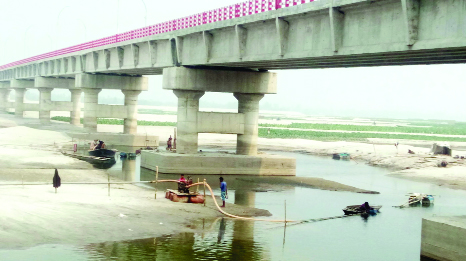 GANGACHARA (Rangpur): Illegal sand lifting continues at Mohipur point near the pillar of under construction Teesta Second Bridge . This snap was taken yesterday.