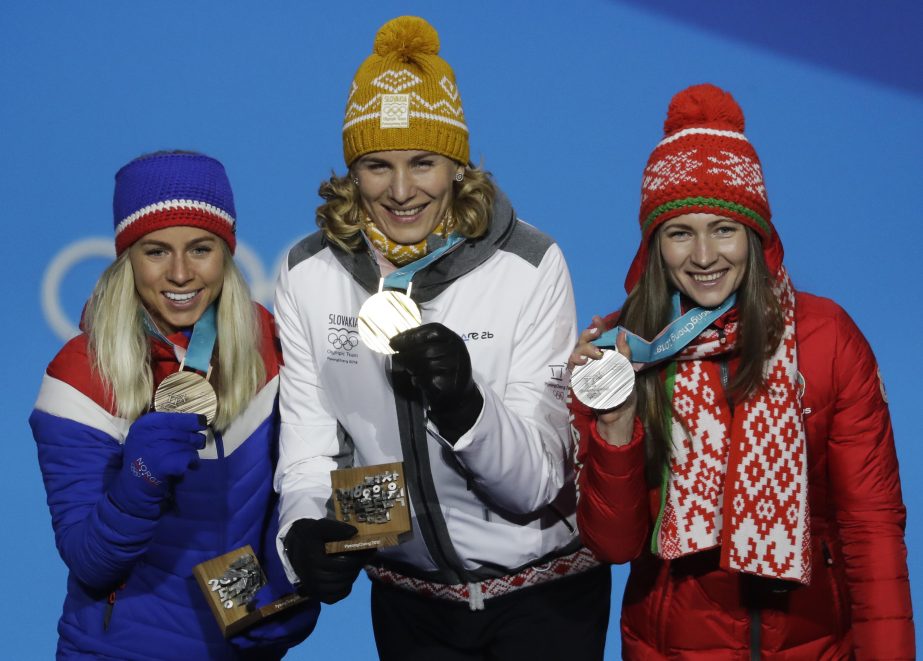 Medalists in the women's 12.5-kilometer mass start biathlon (from right) Belarus' Darya Domracheva (silver), Slovakia's Anastasiya Kuzmina (gold) and Norway's Tiril Eckhoff (bronze) pose during their medals ceremony at the 2018 Winter Olympics in Pyeo