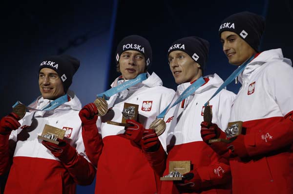 Ski jumping team bronze medalists from Poland smile during their medals ceremony at the 2018 Winter Olympics in Pyeongchang, South Korea on Tuesday.