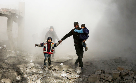 Syria civilians running from area hit by air strikes on the outskirts of the capital Damascus.