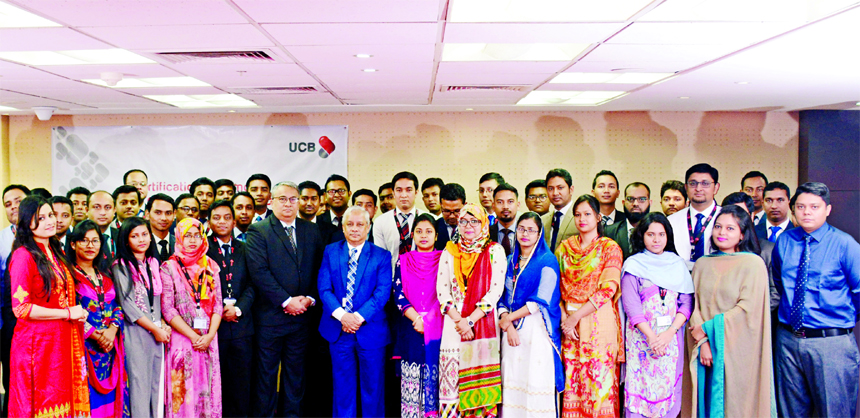 Arif Quadri, Additional Managing Director and Head of Human Resources and Abul Ali Ahad, Head of Learning and Development of United Commercial Bank Limited, pose with the participants of a certification ceremony for the newly joined Probationary officers