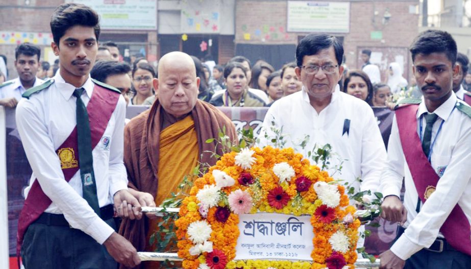 Authority and the students of Banophool Adibashi Green Heart College led by its founder and Chairman of the Governing Body Ven Prajnananda Mahathera placing wreaths at Shaheed Minar on Wednesday.