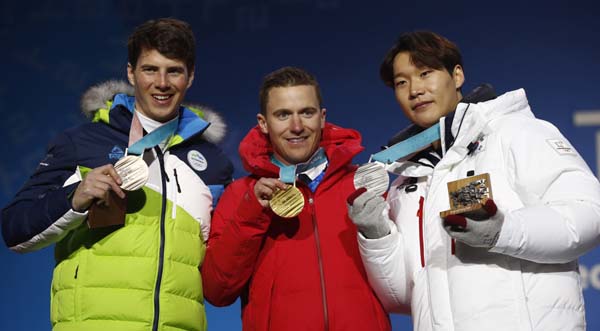 Medalist in the men's parallel giant slalom (from right) South Korea's Lee Sangho (silver), Switzerland's Nevin Galmarini (gold) and Slovenia's Zan Kosir (bronze) pose during their medals ceremony at the 2018 Winter Olympics in Pyeongchang, South Kore