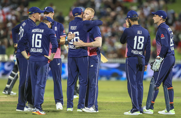 England's Ben Stokes is congratulated by teammates on the wicket of Tom Latham during his teamâ€™s One Day International cricket match against New Zealand in Hamilton, New Zealand on Sunday.