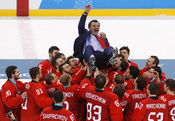 Olympic athletes from Russia celebrate with their coach Oleg Znarok after winning the men's gold medal hockey game against Germany, 4-3 in overtime at the 2018 Winter Olympics in Gangneung, South Korea on Sunday.