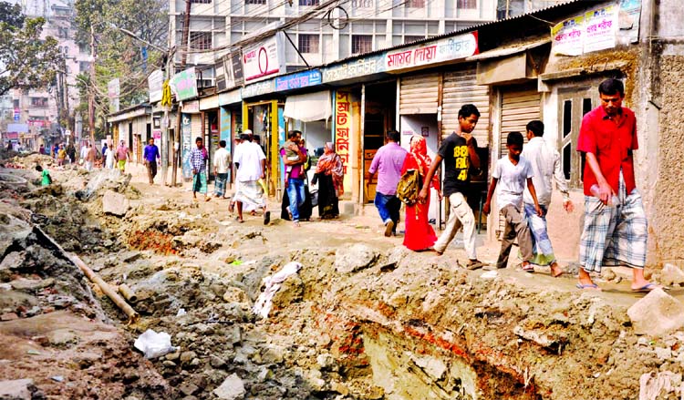 A road in city's Bashabo-Mathertek area is in dilapidated state under Dhaka South City Corporation as under construction work of utility services lying idle for long, causing obstacles to movement of vehicles and pedestrians. This photo was taken on Sund