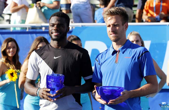 Frances Tiafoe (left) of the U.S. stands with Peter Gojowczyk of Germany after he defeated him 6-1, 6-4 for his first ATP World Tour win in the 2018 Delray Beach OpenÂ in Delray Beach, Fla on Sunday.