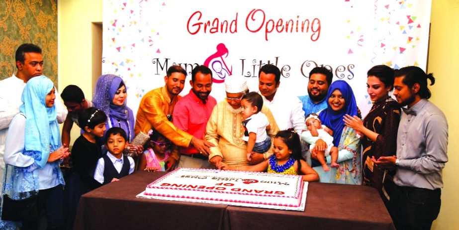 Mohammad Abdul Mannan Miah, Chairman of Mum and Little Ones (Pvt) Ltd, a super store for mother and childcare products, and Mohammad Abdul Hai, Chief Adviser, opening first outlet of the store by cutting a cake at Satmasjid Road in Dhaka recently.