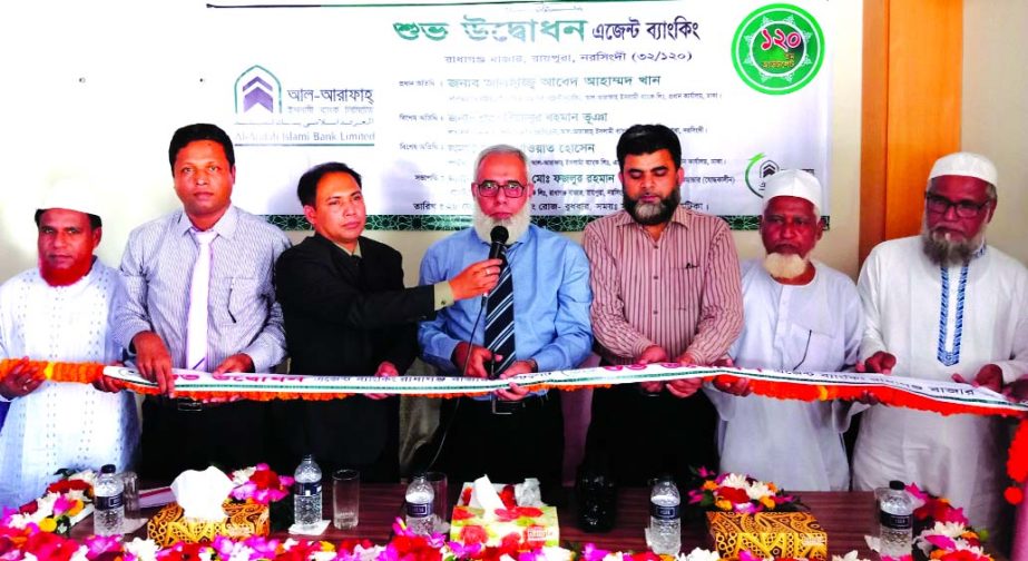 Abed Ahmed Khan, Head of Agent Banking Division of Al-Arafah Islami Bank Limited, inaugurating its 120th 'Agent Banking Outlet' at Radhagonj Bazar in Raipura in Narsgingdi recently. Senior officials of the bank and local elites were also present.