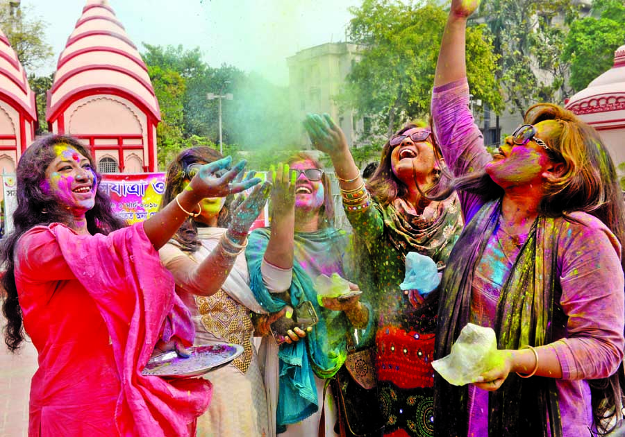 People of the Hindu community celebrating Holi festival. The snap was taken from the premises of Dhakeshwari National Temple in the city on Thursday.